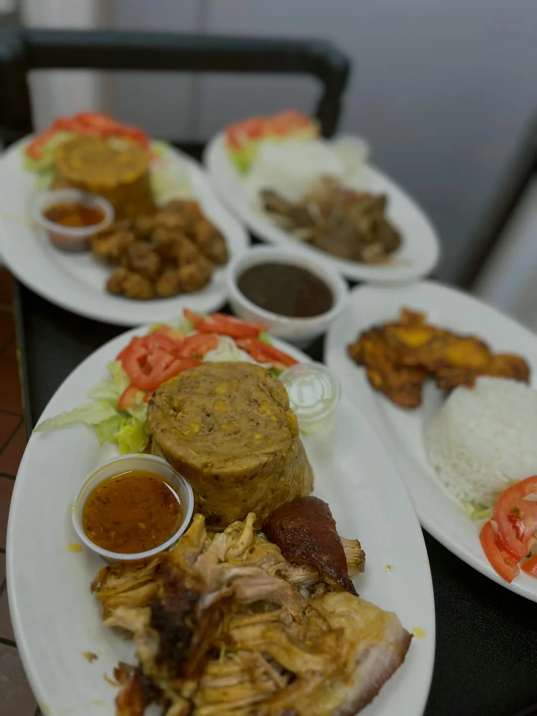 Table set with mofongo, pernil and tostones